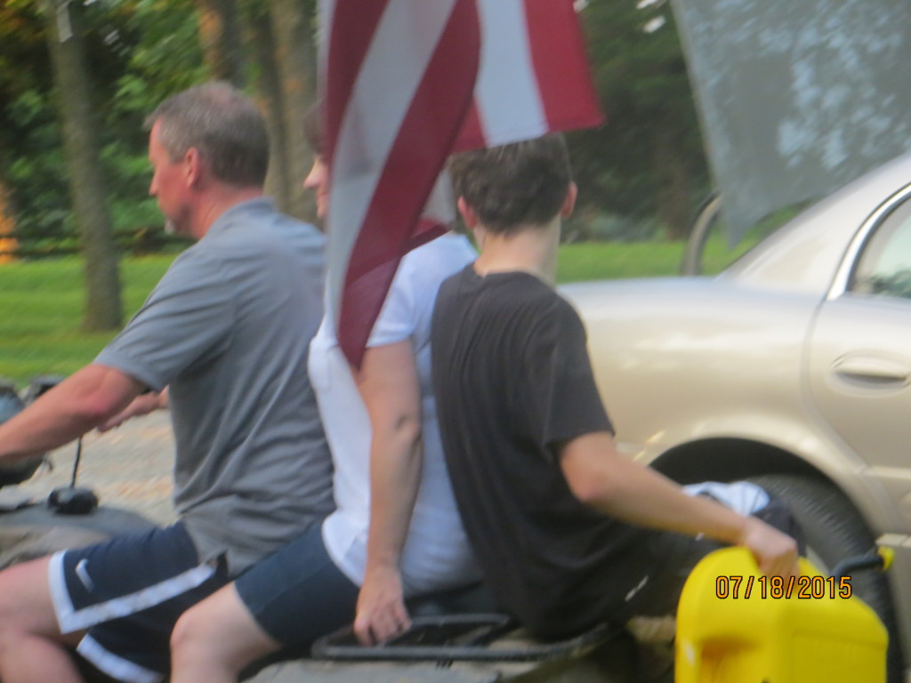 Doug, Kathy an Josh on the 4-wheeler, + flag